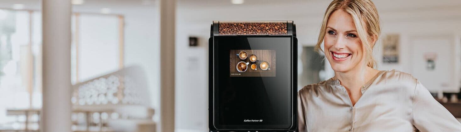 Woman next to coffee machine model Barista Compact