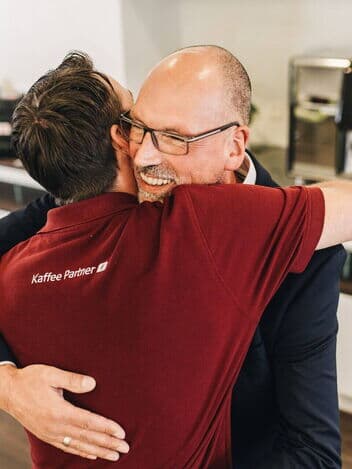 Kunde umarmt dankbar einen Service-Mitarbeiter