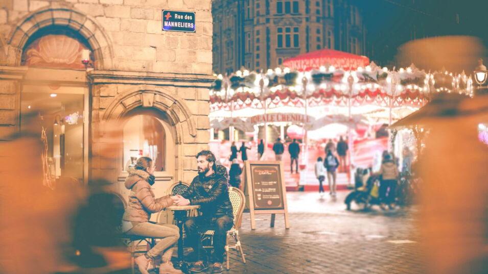 Pärchen in der Stadt sitzen gegenüber vor einem Café