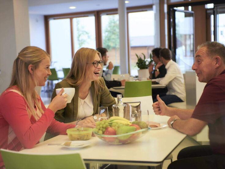 Kaffee Partner's employees at a table