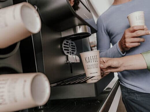 Coffee to go cup in dispenser of coffee machine